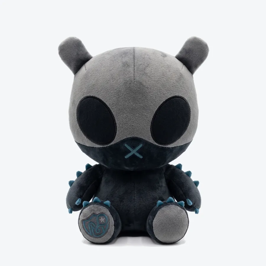 Shado, an almost black plush toy with petrol-blue spikes, seen from the front